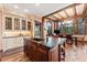 Kitchen featuring island with barstool seating and stainless steel appliances, custom cabinets and hardwood floors at 30 W Ranch Trl, Morrison, CO 80465