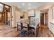 Kitchen featuring large island with seating, custom cabinets, hardwood floors and timber frame accents at 30 W Ranch Trl, Morrison, CO 80465