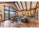 Bright living room featuring a large picture window, stone fireplace, wood floors, and comfortable seating at 30 W Ranch Trl, Morrison, CO 80465