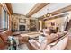 The living room features a fireplace, wood accents and exposed wood beam ceiling at 30 W Ranch Trl, Morrison, CO 80465