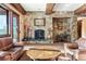 Spacious living room showcases stone fireplace and wood beam ceilings with great light at 30 W Ranch Trl, Morrison, CO 80465