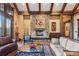 Cozy living room featuring a stone fireplace, comfortable seating, wood floors, and stylish decor at 30 W Ranch Trl, Morrison, CO 80465