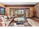 Living room with stone fireplace, beam ceilings, hardwood accents and great light at 30 W Ranch Trl, Morrison, CO 80465
