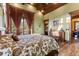 This bedroom has a private balcony, wood ceiling, and hard wood floors at 30 W Ranch Trl, Morrison, CO 80465