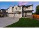 Modern townhome boasts neutral paint, two-car garage and grassy front lawn at 4030 Upham St, Wheat Ridge, CO 80033