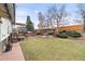 Lush backyard featuring a gazebo, manicured lawn and mature trees at 3355 Wright St, Wheat Ridge, CO 80033