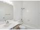 The bathroom has white tiled shower and tub and white vanity at 894 Summer Dr # 15, Highlands Ranch, CO 80126