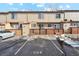 Tan townhome with parking lot in front of the property at 894 Summer Dr # 15, Highlands Ranch, CO 80126