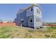 Spacious backyard, showcasing a well-maintained lawn, complemented by the home's exterior and neighborhood view at 542 W 173Rd Ave, Broomfield, CO 80023