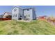 This backyard offers a spacious lawn, patio, ideal for outdoor gatherings, complemented by the home's architecture at 542 W 173Rd Ave, Broomfield, CO 80023
