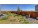 Backyard features a well-maintained lawn, complemented by a charming tree and privacy fence at 542 W 173Rd Ave, Broomfield, CO 80023