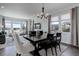 Bright dining room with a large table, modern light fixture, and multiple windows for natural light at 542 W 173Rd Ave, Broomfield, CO 80023