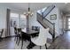 The dining room features a stylish chandelier and staircase leading to the upper level at 542 W 173Rd Ave, Broomfield, CO 80023