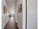 Hallway with hardwood floors, wall art, and a view into a bright, open living area at 542 W 173Rd Ave, Broomfield, CO 80023