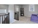 Well-lit landing area with comfortable furniture, a bookshelf and a view from the window at 542 W 173Rd Ave, Broomfield, CO 80023