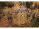 Aerial view of a property with a private backyard and multiple buildings surrounded by trees at 2971 Fall River Rd, Idaho Springs, CO 80452