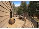Outdoor patio area with a fire pit and seating with a tree-filled backdrop at 2971 Fall River Rd, Idaho Springs, CO 80452