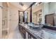 Bathroom with dual vanities, vessel sinks, granite countertop and walk-in glass shower at 2971 Fall River Rd, Idaho Springs, CO 80452
