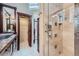 Stylish bathroom featuring dual vanities, granite countertop, a walk-in glass shower and custom wood finishes at 2971 Fall River Rd, Idaho Springs, CO 80452