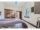 Cozy bedroom with a comfortable bed, hardwood floors, and a large window for natural light at 2971 Fall River Rd, Idaho Springs, CO 80452