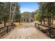 Charming single-Gathering home with stone exterior and wooded surroundings, viewed from the bridge at 2971 Fall River Rd, Idaho Springs, CO 80452
