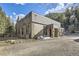 Charming home exterior with stone and shingle accents and gravel driveway at 2971 Fall River Rd, Idaho Springs, CO 80452