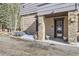 Exterior featuring stone accents and a dark wood front door at 2971 Fall River Rd, Idaho Springs, CO 80452