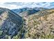 Aerial view of a forested valley, highlighting the picturesque landscape and mountain setting at 2971 Fall River Rd, Idaho Springs, CO 80452