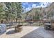 Stamped concrete patio with mountain views, black metal railing, fire pit, grill and outdoor furniture set at 2971 Fall River Rd, Idaho Springs, CO 80452