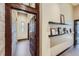 Hallway with dark wooden trim, built-in shelving, and plenty of natural light at 2971 Fall River Rd, Idaho Springs, CO 80452