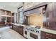 Gourmet kitchen featuring stone backsplash, stainless steel range, and custom cabinetry at 2971 Fall River Rd, Idaho Springs, CO 80452