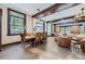 Spacious living room and dining area with hardwood floors, exposed beams, and large windows offering great natural light at 2971 Fall River Rd, Idaho Springs, CO 80452