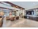 Cozy living room features exposed beams, a stone fireplace, custom built-ins and patio access at 2971 Fall River Rd, Idaho Springs, CO 80452