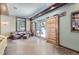 Inviting bonus living room area with a sliding barn doors opening to patio views and exposed beams at 2971 Fall River Rd, Idaho Springs, CO 80452