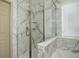 Modern bathroom with a glass shower and marble tile at 7051 S Oak Hill Cir, Aurora, CO 80016