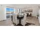 Elegant dining area with large windows, chandelier, and views of the wintery outdoors at 850 Mosquito Ct, Elizabeth, CO 80107