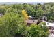 Aerial view showcasing a house nestled among lush trees, blending privacy with natural beauty at 1040 Zang St, Golden, CO 80401