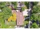 Aerial view of a well-maintained property with a large backyard, mature trees, and a long driveway at 1040 Zang St, Golden, CO 80401