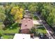 An aerial view of a property featuring a large yard, mature trees, and an expansive driveway at 1040 Zang St, Golden, CO 80401
