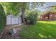 Landscaped backyard featuring a storage shed, lawn, and patio area at 1040 Zang St, Golden, CO 80401