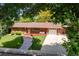 Charming red brick home with a manicured lawn, front porch, and a spacious driveway at 1040 Zang St, Golden, CO 80401