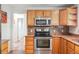 Well-equipped kitchen with stainless steel appliances and natural wood cabinets at 1040 Zang St, Golden, CO 80401