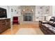 Inviting living room with a stone fireplace, built-in shelves, and hardwood floors at 1040 Zang St, Golden, CO 80401