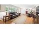 Bright living room with hardwood floors and lots of natural light from large windows at 1040 Zang St, Golden, CO 80401