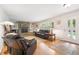Bright living room featuring a stone fireplace, hardwood floors, and large windows at 1040 Zang St, Golden, CO 80401