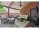 Comfortable covered outdoor patio with ceiling fan, wicker furniture, and brick accents at 1040 Zang St, Golden, CO 80401