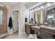 Luxurious bathroom with dual vanities, a glass-enclosed shower, and elegant tile work at 583 S York St, Denver, CO 80209
