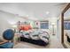 Bright bedroom with a floral bedspread, neutral carpet, and an antique bed frame at 583 S York St, Denver, CO 80209