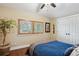 Cozy bedroom with a large window and wood shutters, complemented by hardwood floors and stylish decor at 583 S York St, Denver, CO 80209
