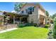 Charming two-story home featuring a well-maintained lawn and a delightful outdoor living area for relaxation and entertainment at 583 S York St, Denver, CO 80209